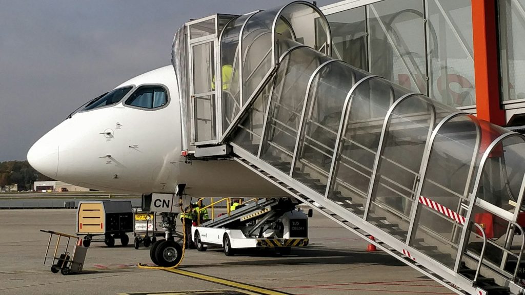 Passenger jet parked at an airport gate with a jet bridge