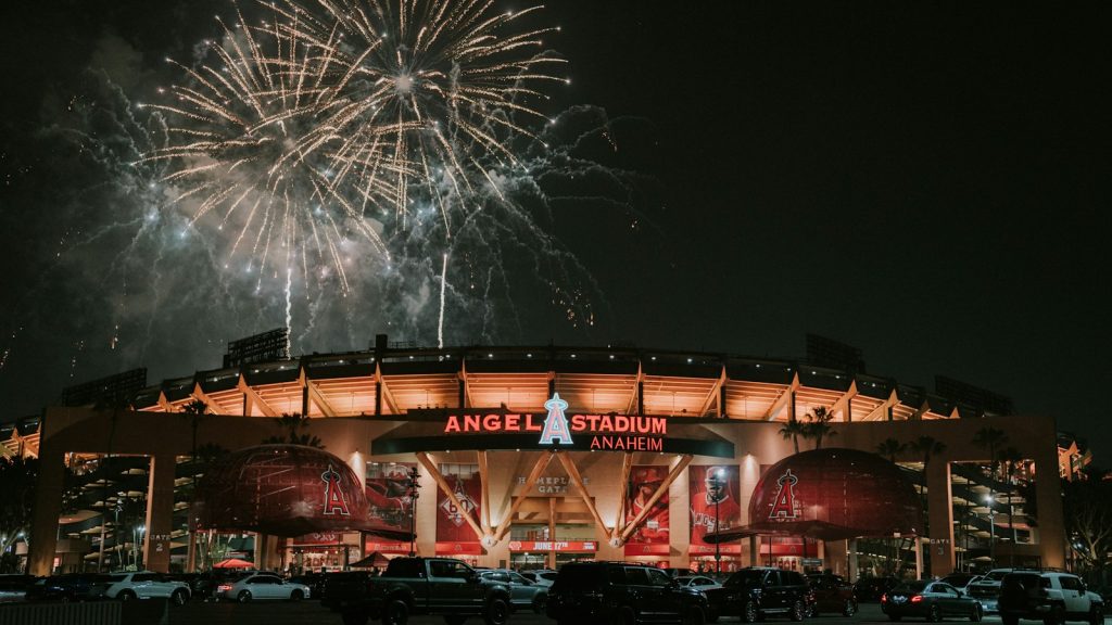 Fireworks bursting above a stadium at night