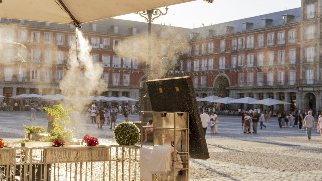 Misting system cooling an outdoor café in Madrid's Plaza Mayor