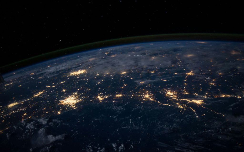 Earth seen from space at night with city lights across continents