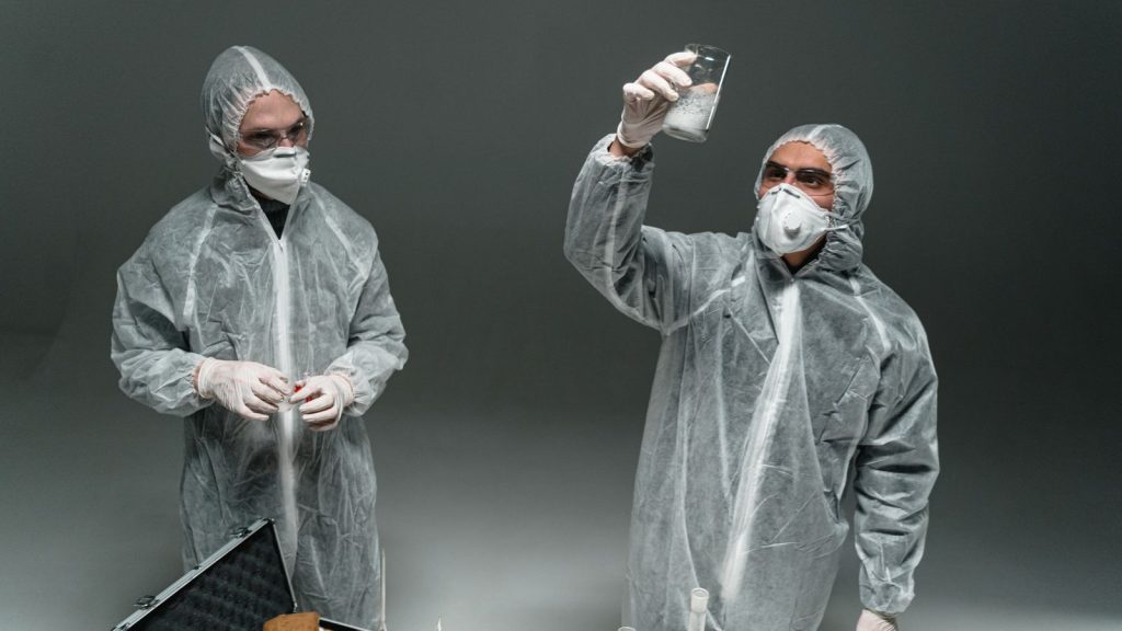 Health workers in full white protective suits