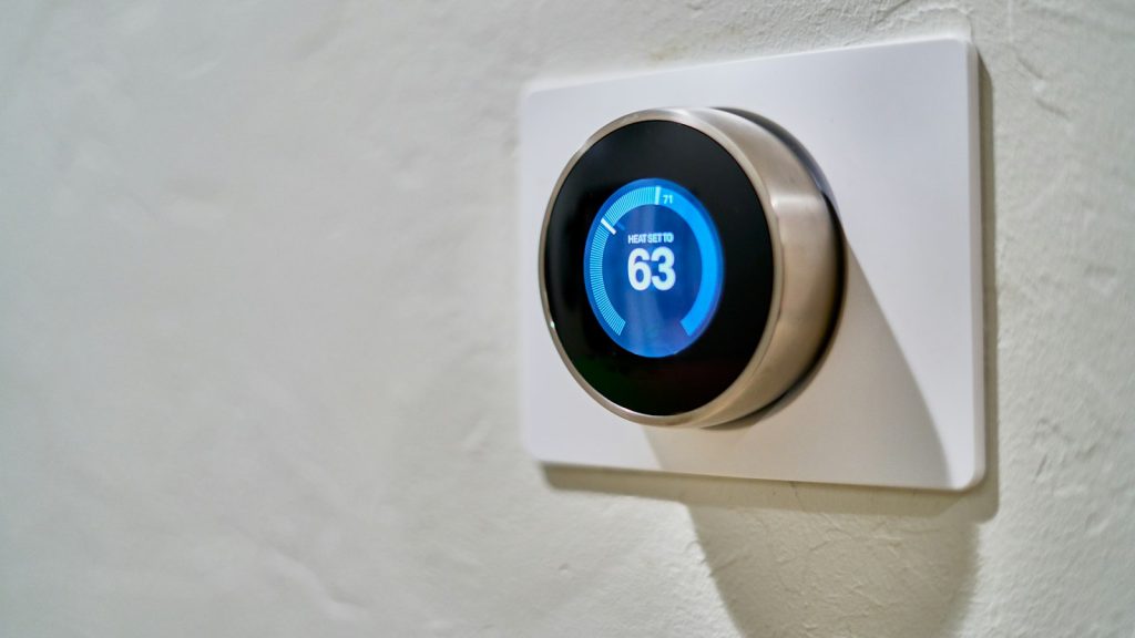 Smart thermostat on a living-room wall