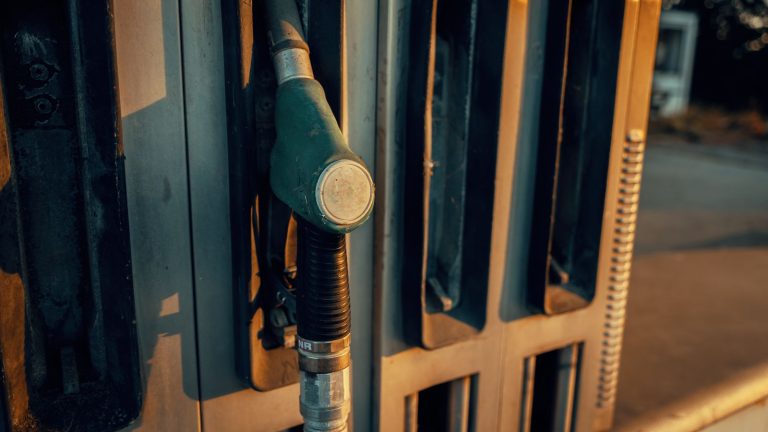 Close-up of a fuel pump nozzle at a petrol station