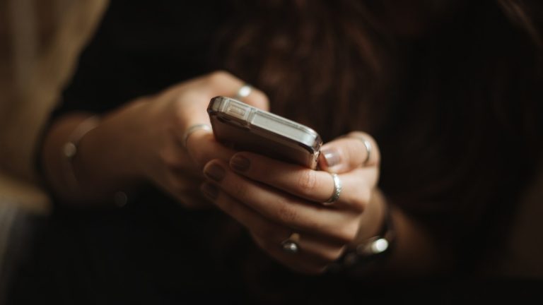 Hands holding and using a smartphone