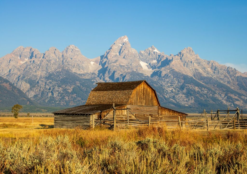 Historic wooden barn beneath the snow-capped Teton Range near Jackson, Wyoming