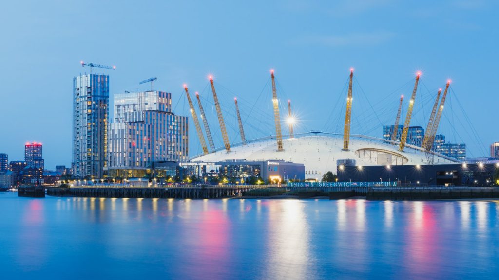 The O2 arena on London's Greenwich Peninsula at dusk, seen across the River Thames