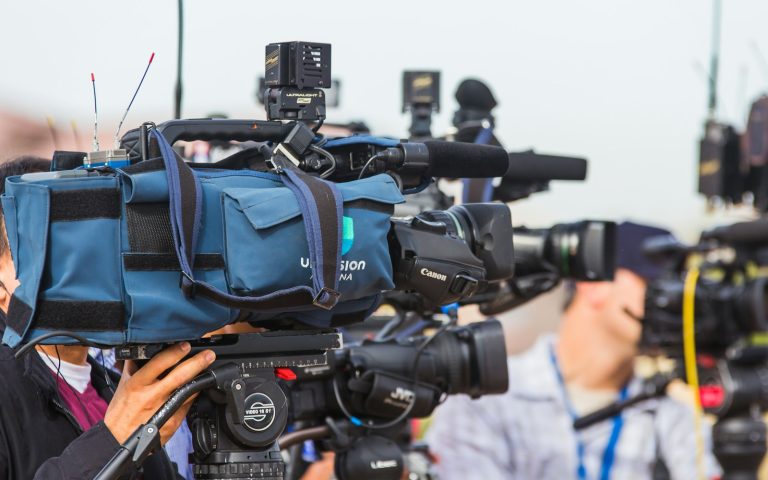 Professional video camera set up to record a news event