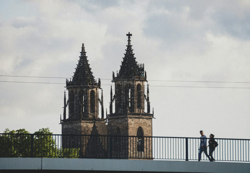 People walking past Magdeburg Cathedral in Saxony-Anhalt, Germany