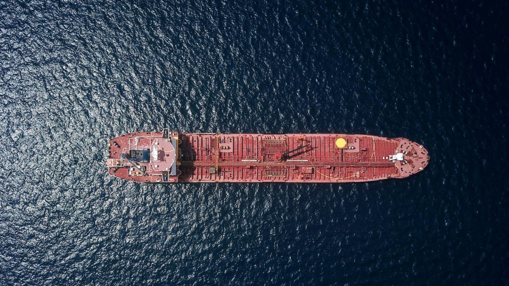 Aerial view of a red oil tanker sailing on open sea