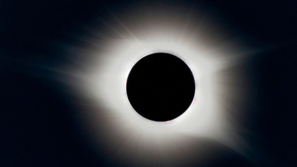 Total solar eclipse with the white corona glowing around the Moon