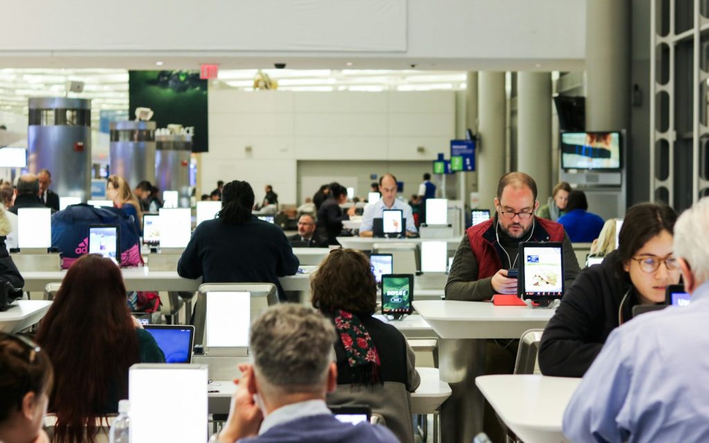 Journalists working at desks in a busy open-plan newsroom